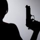 Silhouette of a woman with gun